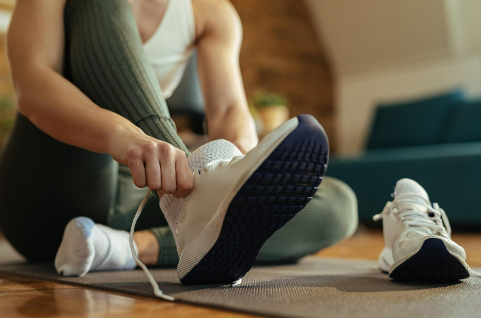 A lady slowly inserting her Replica sneakers on