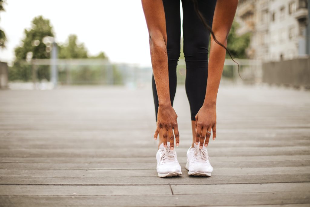 Performing touch your toes exercise in replica training sneakers